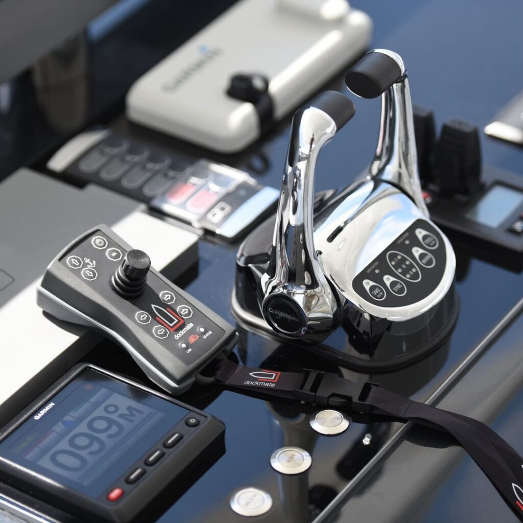Dockmate remote control placed on a boat console next to the engine controls, illustrating a wireless docking system that allows precise remote control and maneuvering of a boat during port maneuvers.